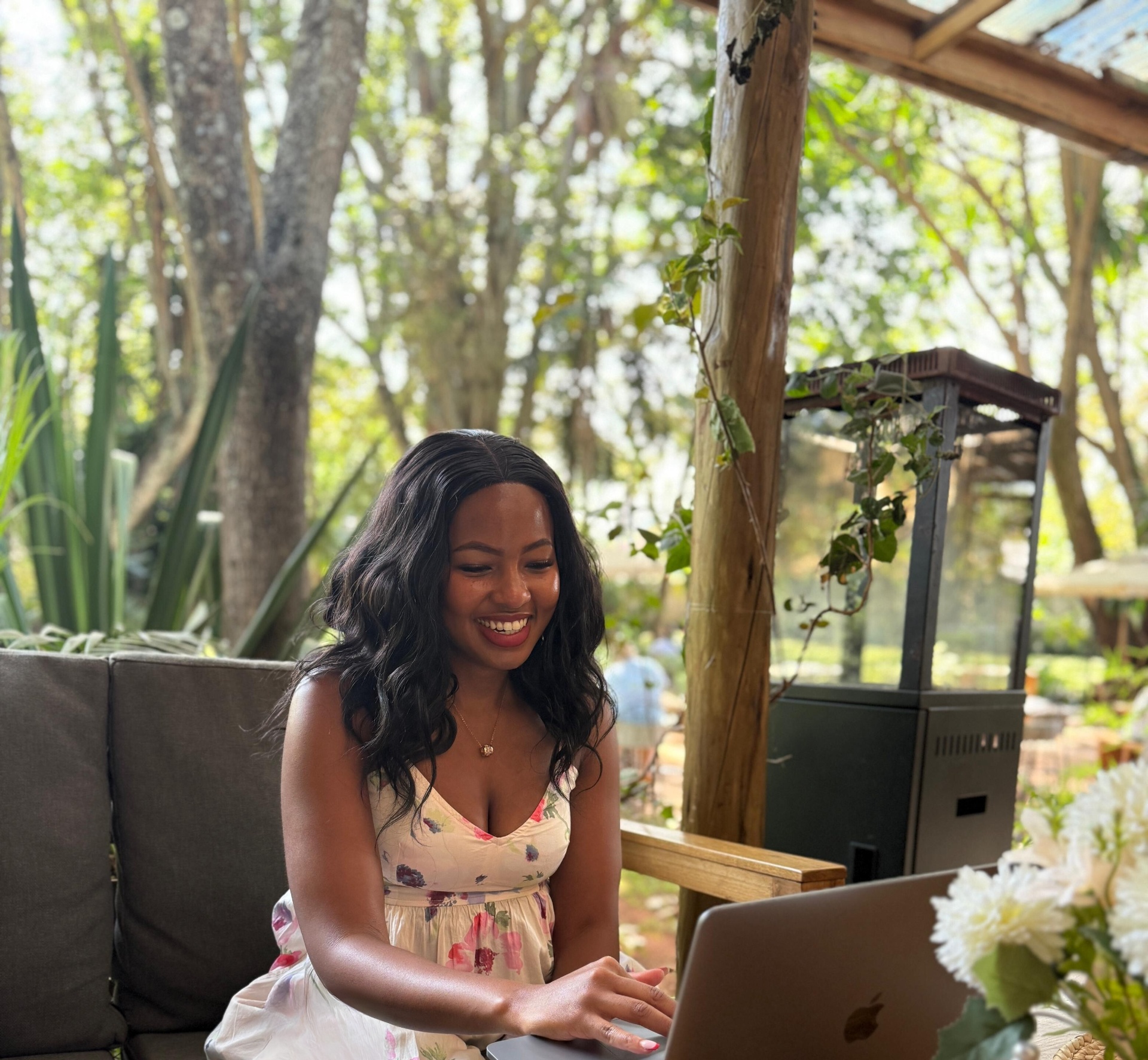 Sabrina working outdoors among trees and plants
